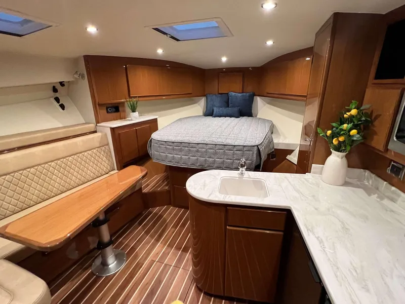 Slide: The Image of Luxurious interior of 2025 Henriques 42 Express yacht with bed, seating, and kitchenette. - 15