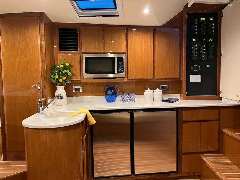 Slide: The Image of Henriques 42 Express 2025 yacht kitchen with modern appliances and wooden cabinetry. - 16