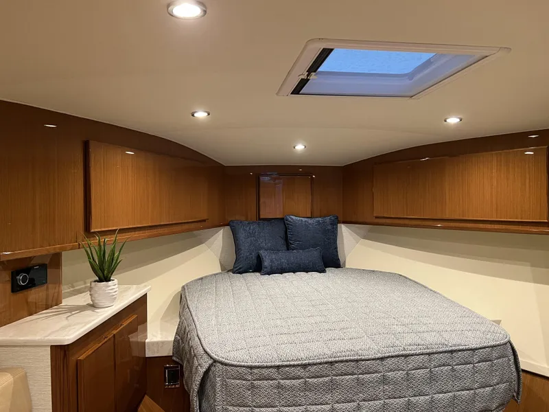 Slide: The Image of 2025 Henriques 42 Express cabin with bed, skylight, and wooden cabinetry. - 17