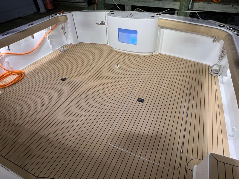 Slide: The Image of Henriques 42 Express 2025 boat deck with teak flooring and storage compartments. - 8
