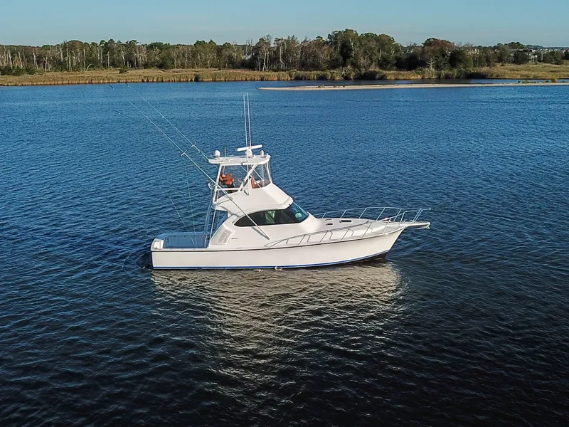 The Image of 2025 Henriques 42 EXHTB boat on calm water with scenic background. - 0