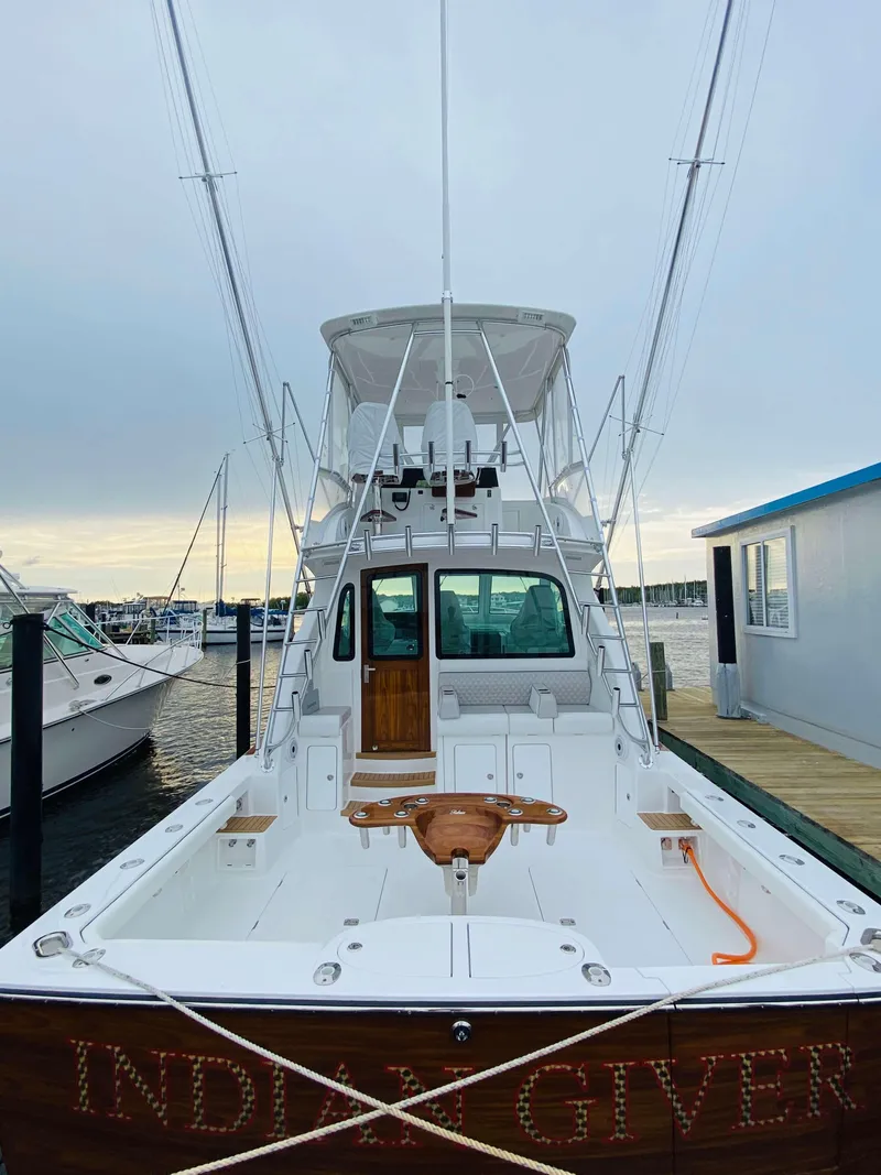 Slide: The Image of 2025 Henriques 42 EXHTB boat docked at a marina. - 11