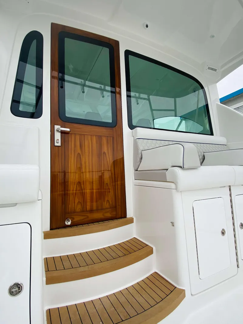 Slide: The Image of 2025 Henriques 42 EXHTB yacht with teak steps and wooden door. - 13
