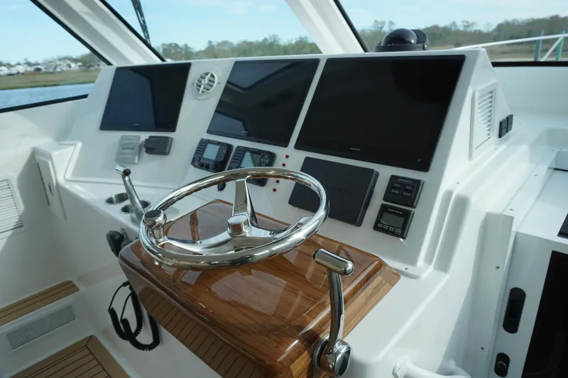 Slide: The Image of Helm station of 2025 Henriques 42 EXHTB with modern navigation equipment. - 15