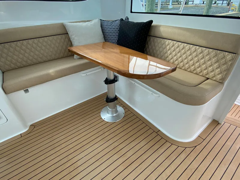 Slide: The Image of Elegant seating area with a wooden table on the 2025 Henriques 42 EXHTB yacht. - 16