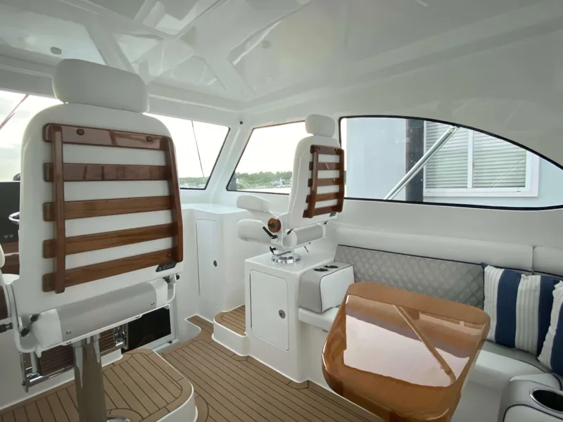 Slide: The Image of Interior of 2025 Henriques 42 EXHTB boat with white and wood accents. - 17