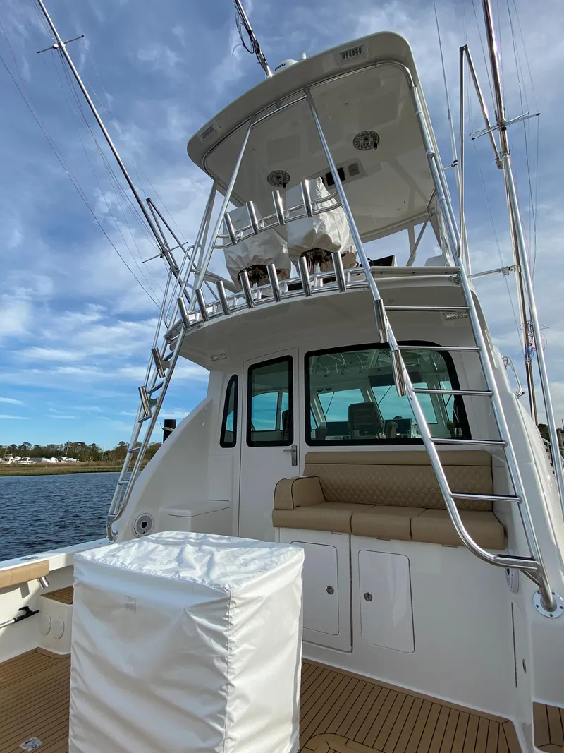 Slide: The Image of 2025 Henriques 42 EXHTB boat with upper deck and seating area. - 6