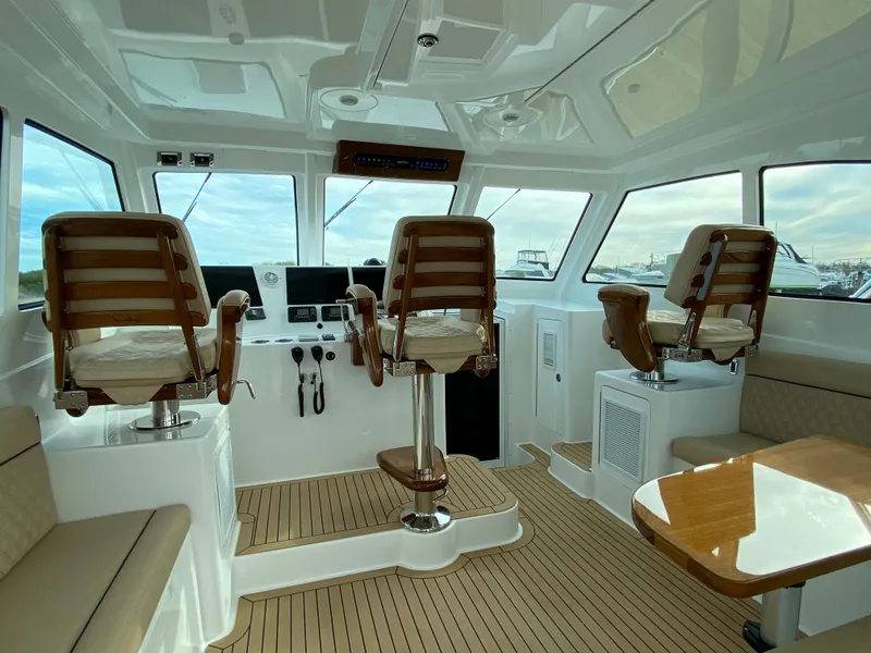 Slide: The Image of Interior of 2025 Henriques 42 EXHTB boat with helm chairs and navigation equipment. - 14