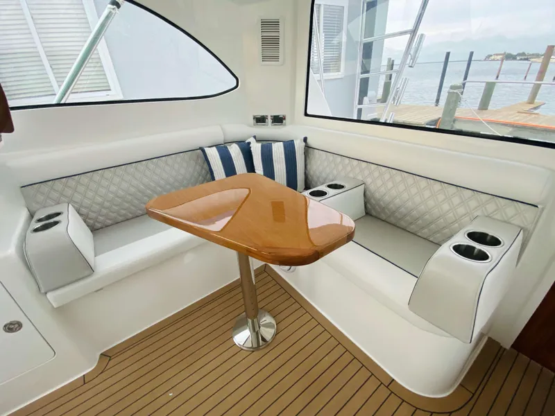 Slide: The Image of Luxurious seating area on the 2025 Henriques 42 EXHTB yacht with a wooden table. - 18