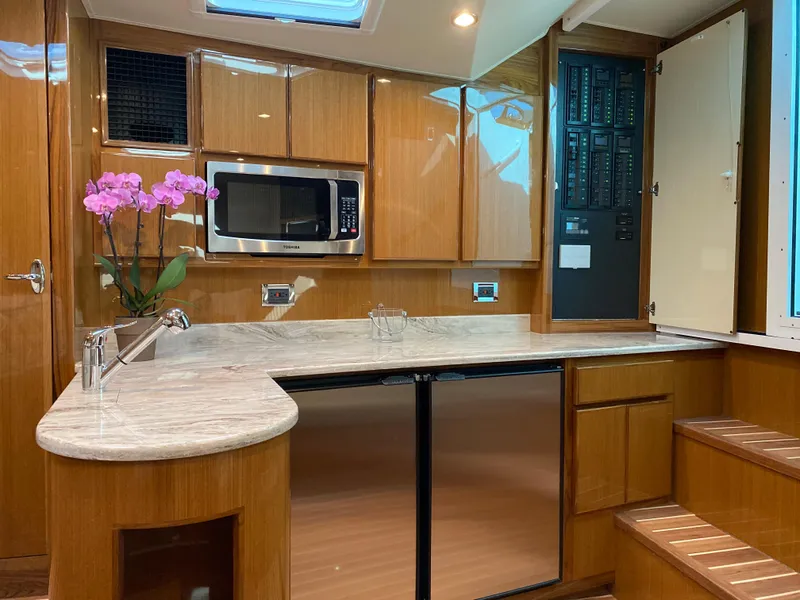Slide: The Image of Modern kitchen in 2025 Henriques 42 EXHTB yacht with wood cabinets and marble countertops. - 21