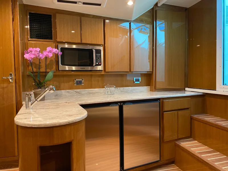Slide: The Image of Modern kitchen in 2025 Henriques 42 EXHTB yacht with wood cabinets and stainless steel appliances. - 22