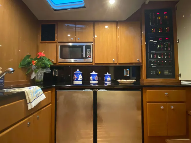 Slide: The Image of Modern kitchen in 2025 Henriques 42 EXHTB yacht with microwave, cabinets, and control panel. - 26