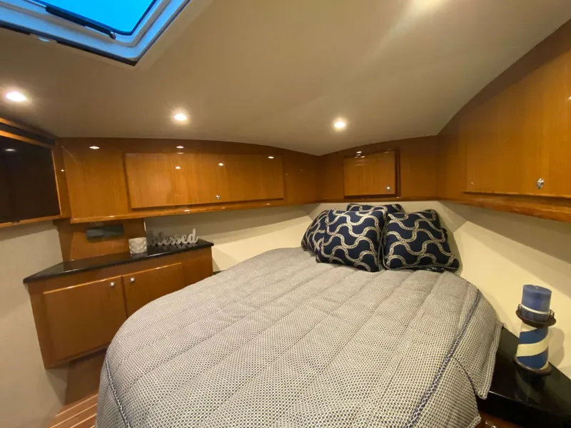 Slide: The Image of Luxurious bedroom in 2025 Henriques 42 EXHTB yacht with cozy bedding and wooden cabinets. - 28