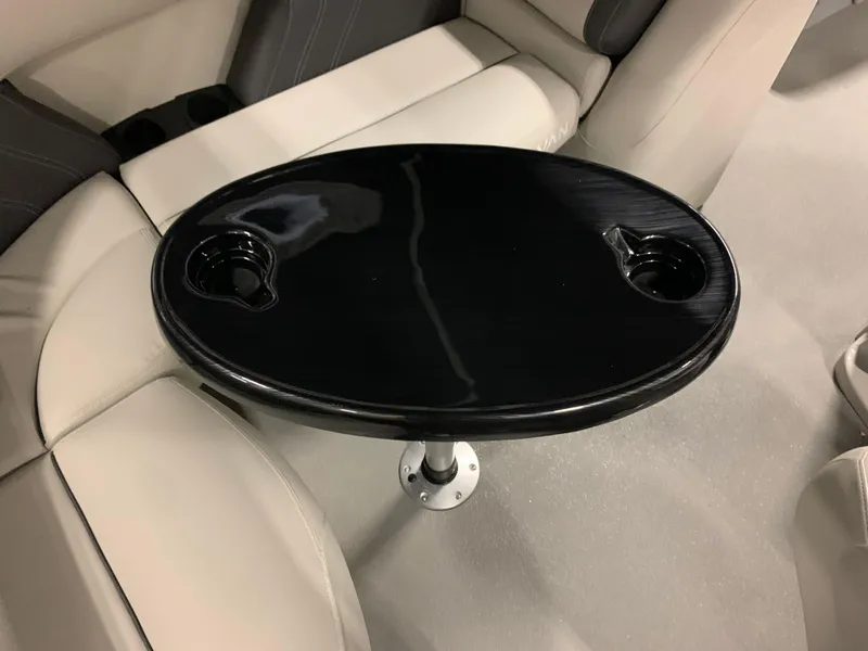 Slide: The Image of Black table with cup holders in Sylvan Mirage 818 Cruise 2026. - 10