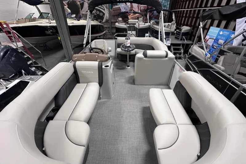 Slide: The Image of 2026 Sylvan Mirage 818 Cruise pontoon boat interior with plush seating and modern design. - 19