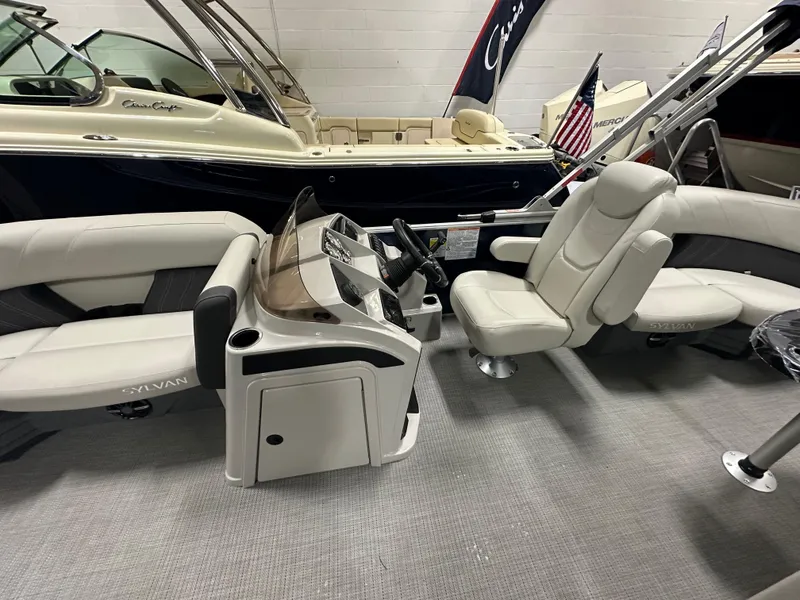 Slide: The Image of 2026 Sylvan Mirage 8520 LZ interior with plush seating and modern dashboard in showroom. - 10