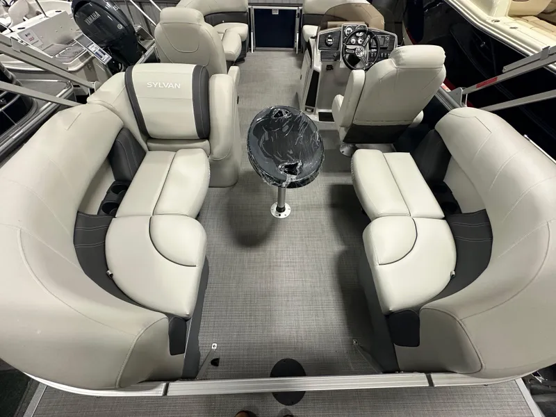 Slide: The Image of 2026 Sylvan Mirage 8520 LZ pontoon boat interior with plush seating and modern helm. - 8