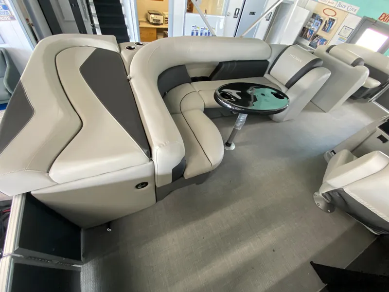 Slide: The Image of 2022 Sylvan Mirage 8522 Cruise interior with plush seating and a sleek table. - 3