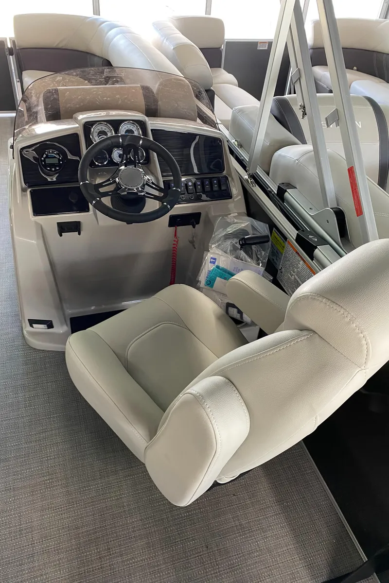 Slide: The Image of 2022 Sylvan Mirage 8522 Cruise boat interior with captain's chair and control console. - 7