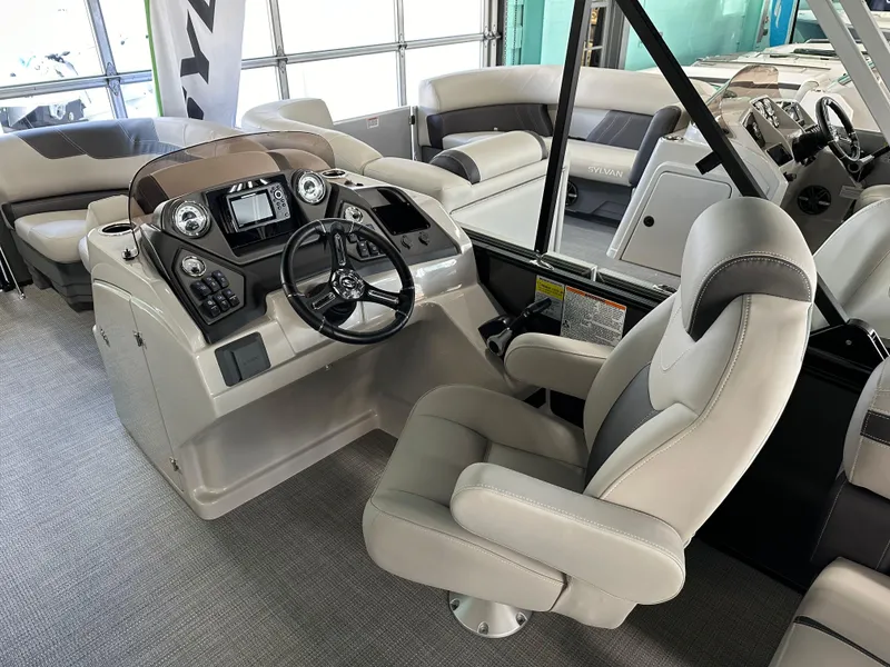 Slide: The Image of 2025 Sylvan Mirage L-1 LZ pontoon boat interior with luxurious seating and modern design. - 5