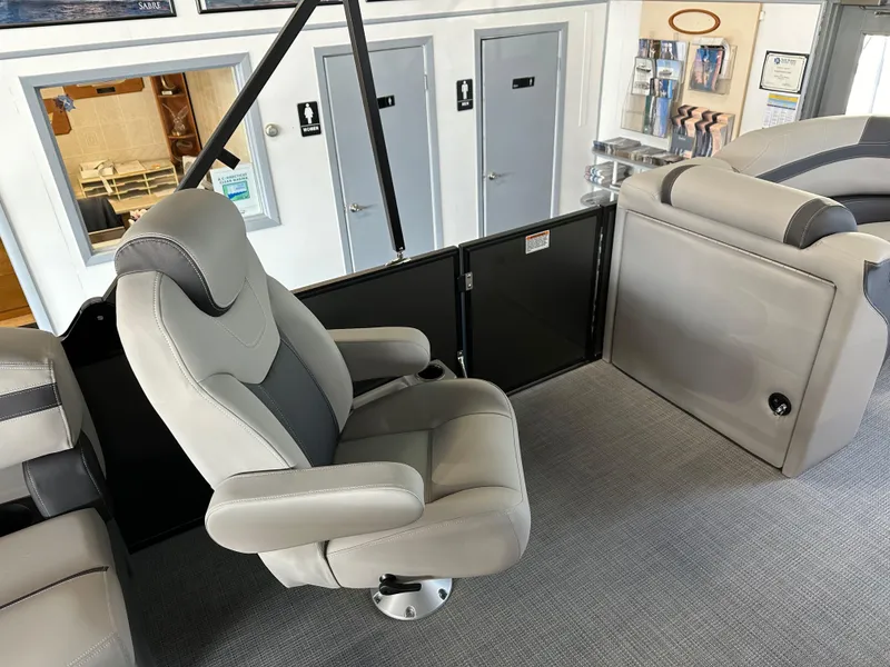 Slide: The Image of 2025 Sylvan Mirage L-1 LZ boat dashboard with steering wheel and control panel. - 7