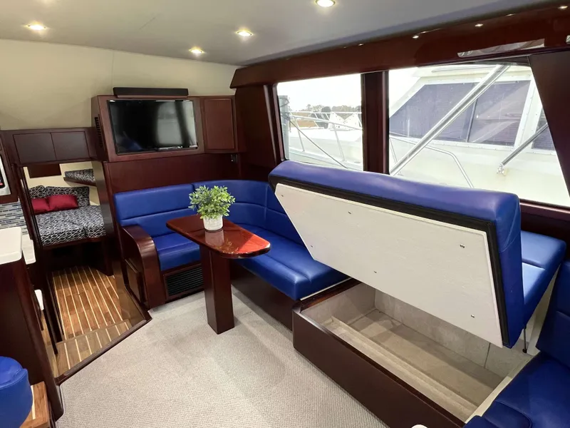 Slide: The Image of Luxurious interior of 2025 Henriques 42 Flybridge yacht with blue seating and modern amenities. - 11