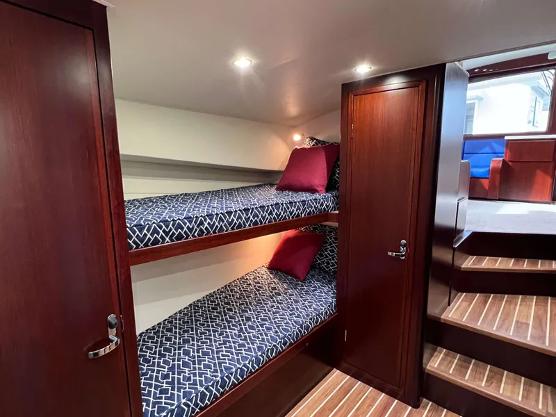 Slide: The Image of Bunk beds in 2025 Henriques 42 Flybridge yacht cabin with wooden interior and modern lighting. - 15