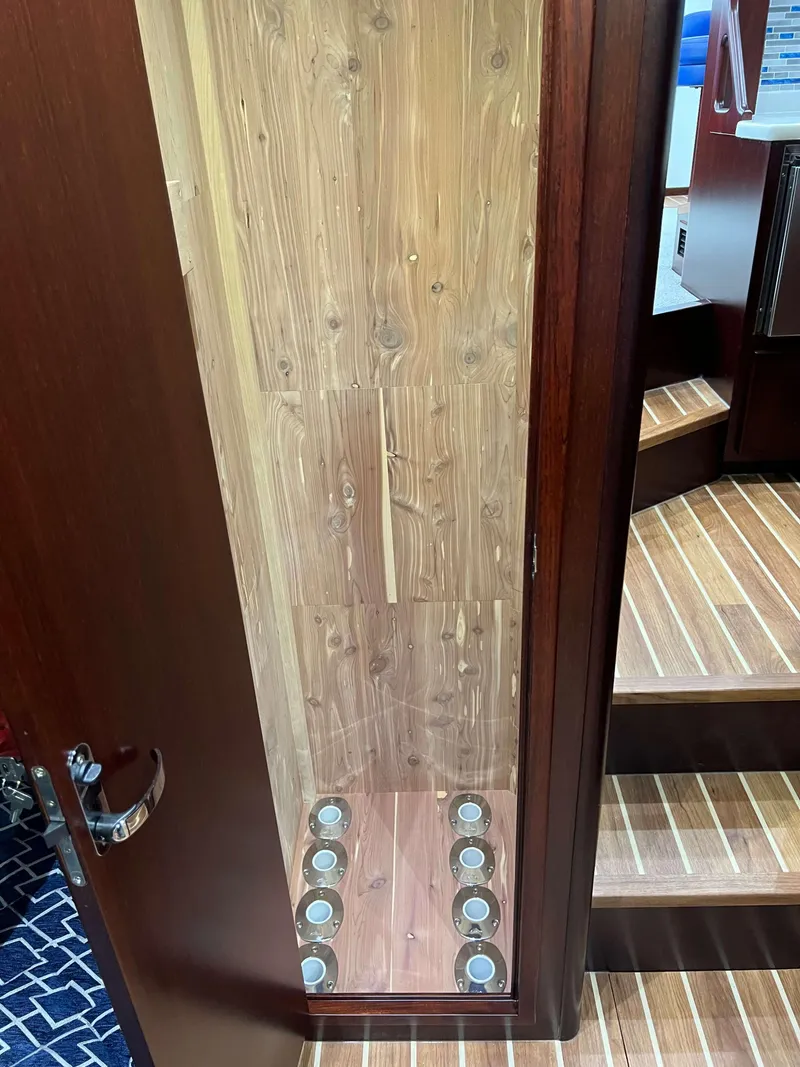 Slide: The Image of Interior view of 2025 Henriques 42 Flybridge, showcasing wooden paneling and recessed lighting. - 16