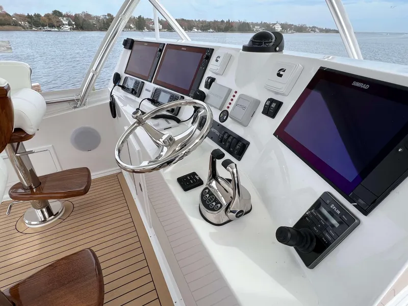 Slide: The Image of Helm of 2025 Henriques 42 Flybridge with advanced navigation systems and controls. - 36