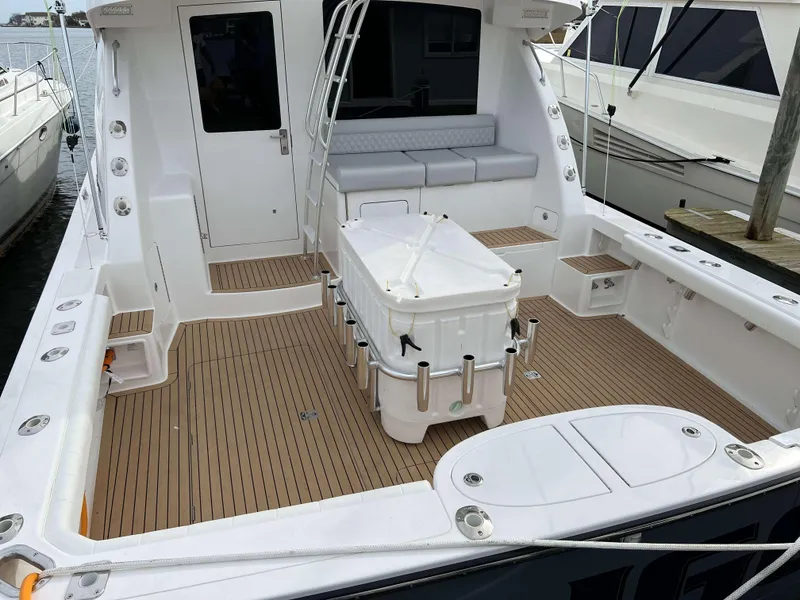 Slide: The Image of 2025 Henriques 42 Flybridge boat with spacious deck and seating area. - 5