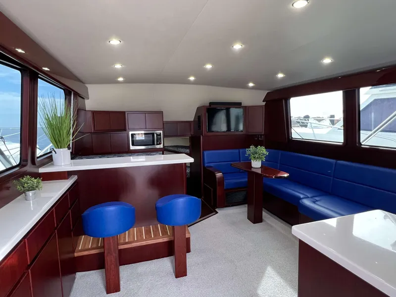 Slide: The Image of Luxurious interior of 2025 Henriques 42 Flybridge yacht with modern seating and kitchen area. - 7