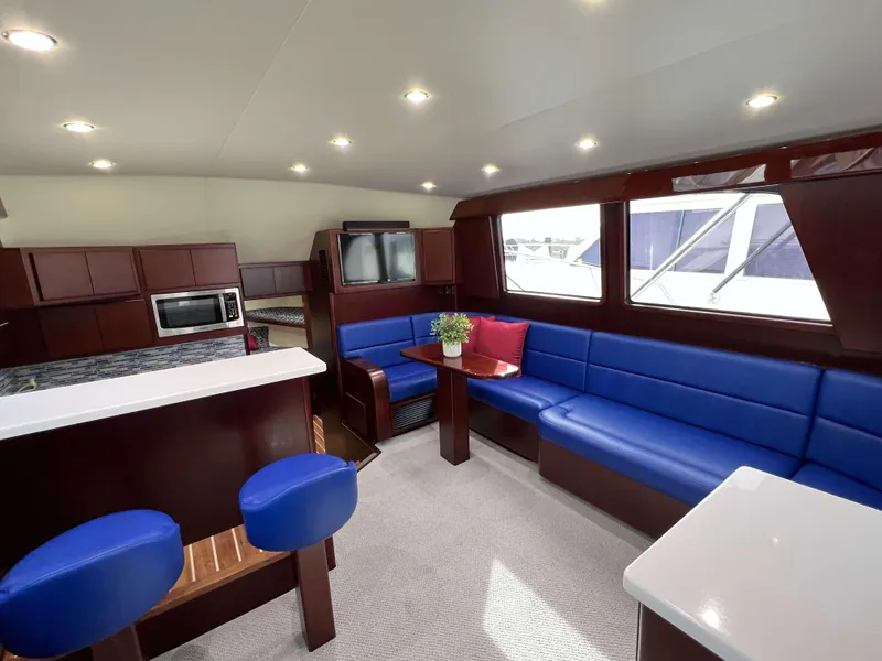 Slide: The Image of Luxurious interior of 2025 Henriques 42 Flybridge yacht with blue seating and modern kitchen. - 8