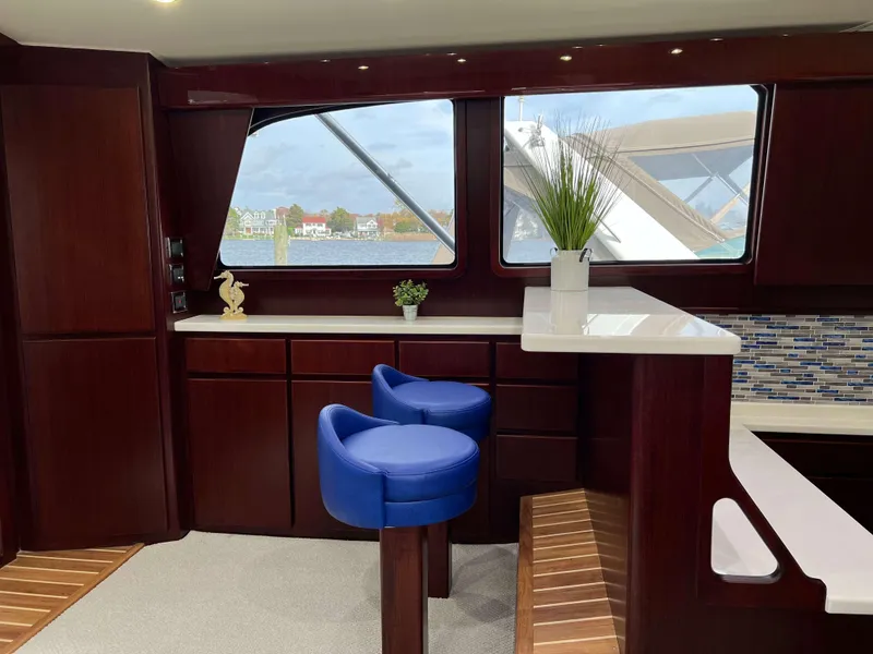 Slide: The Image of Luxurious interior of 2025 Henriques 42 Flybridge with modern decor and blue seating. - 9