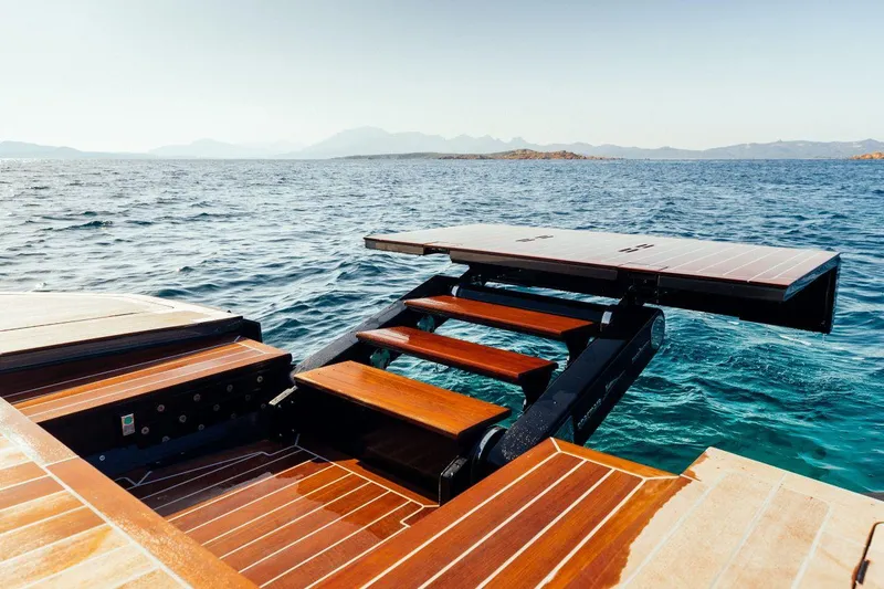 Slide: The Image of Luxury Maori 54 yacht with extended swim platform, 2020 model, on a serene ocean backdrop. - 12