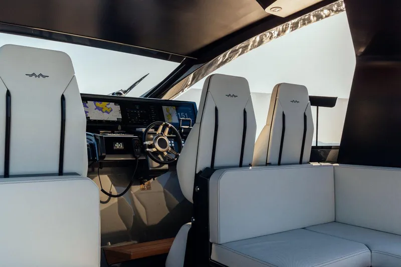 Slide: The Image of Interior of a 2020 Maori 54 yacht with white leather seats and modern dashboard. - 17