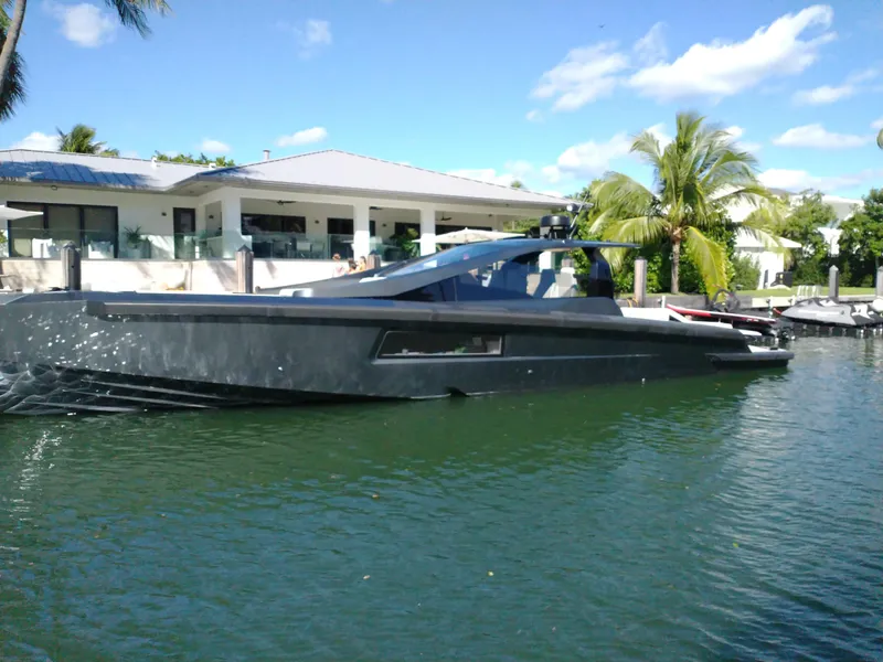 Slide: The Image of Luxury Maori 54 yacht docked near modern waterfront home, 2020 model. - 2