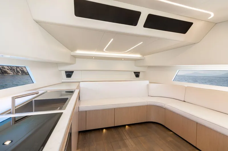 Slide: The Image of Modern interior of 2020 Maori 54 yacht with white seating and panoramic windows. - 21