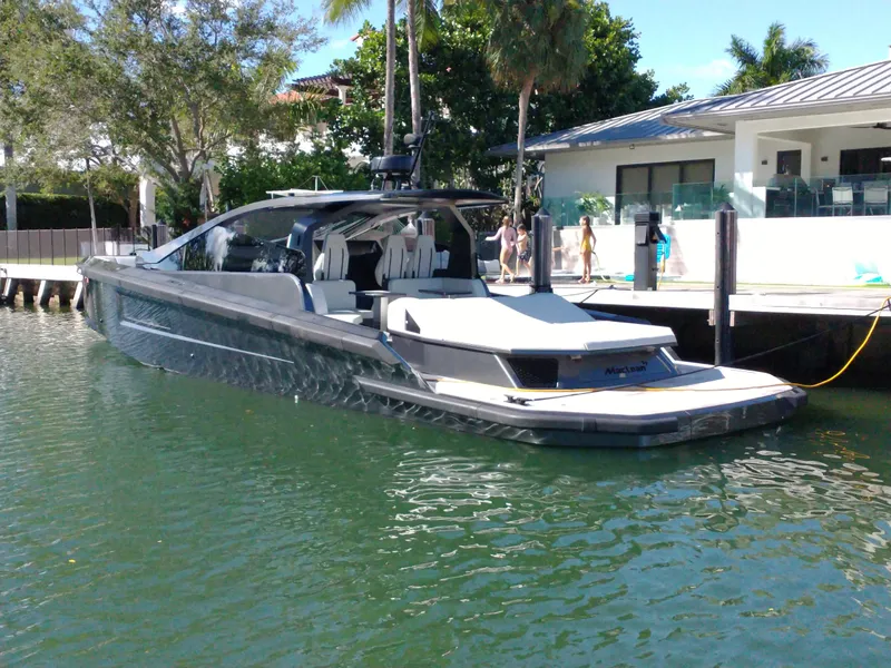 Slide: The Image of 2020 Maori 54 luxury yacht docked by waterfront home. - 3