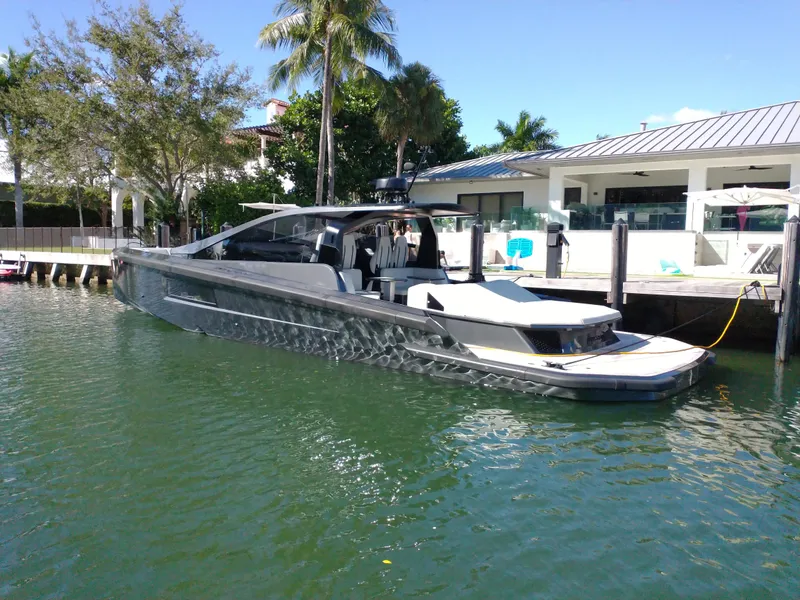 Slide: The Image of Luxury Maori 54 yacht docked at a modern waterfront property, 2020 model. - 4