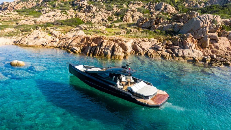 Slide: The Image of Luxury Maori 54 yacht cruising in clear blue waters near rocky coastline, 2020 model. - 8