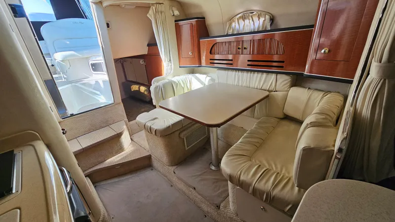 Slide: The Image of Interior of 2003 Sea Ray 280 Sundancer with dining area and seating. - 15