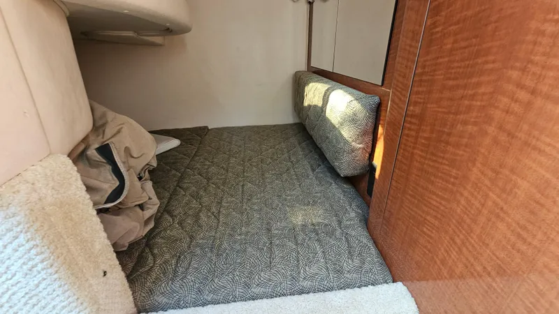 Slide: The Image of Interior cabin of 2003 Sea Ray 280 Sundancer with bed and storage space. - 20