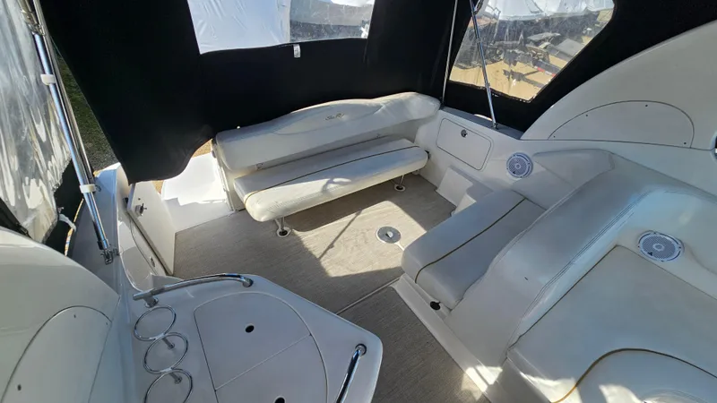 Slide: The Image of 2003 Sea Ray 280 Sundancer boat interior with seating and cup holders. - 6