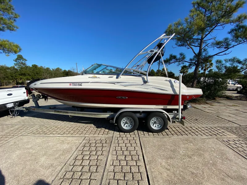 Slide: The Image of 2006 Sea Ray 200 Sundeck boat on trailer, parked outdoors. - 10