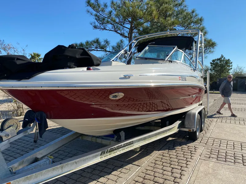 Slide: The Image of 2006 Sea Ray 200 Sundeck boat on trailer, parked outdoors. - 11