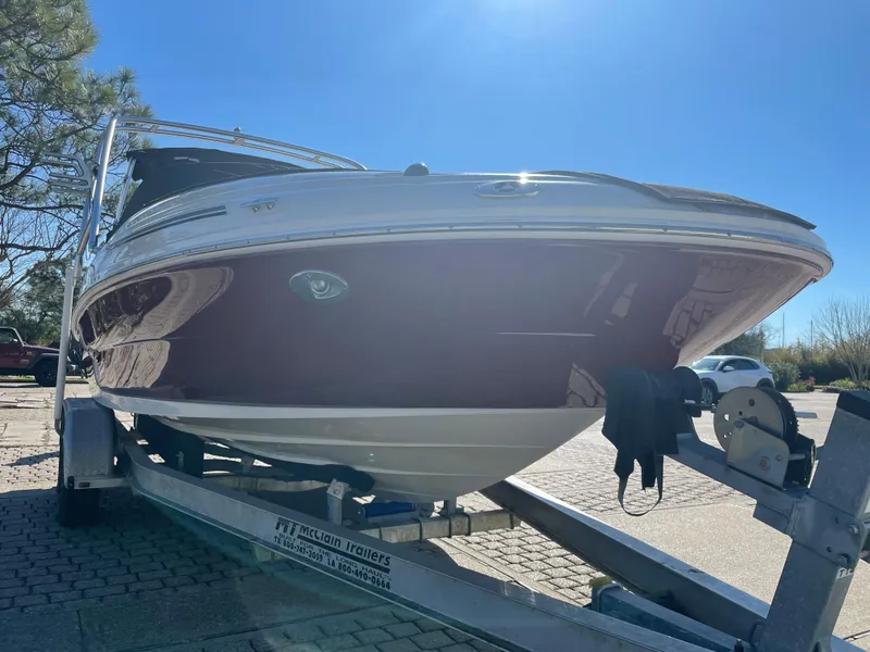 Slide: The Image of 2006 Sea Ray 200 Sundeck boat on trailer under clear blue sky. - 2