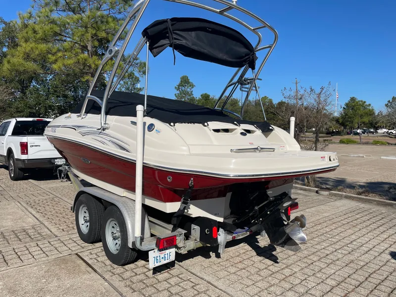 Slide: The Image of 2006 Sea Ray 200 Sundeck boat on trailer in parking lot. - 4