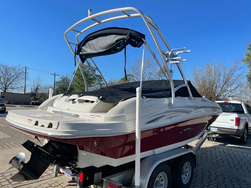 Slide: The Image of 2006 Sea Ray 200 Sundeck boat on trailer, sunny day, outdoor setting. - 5