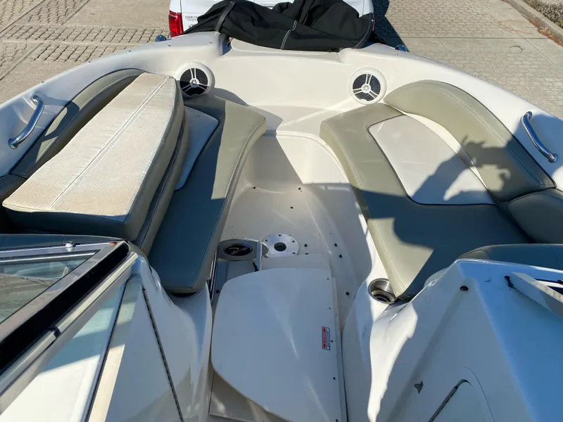 Slide: The Image of 2006 Sea Ray 200 Sundeck boat interior with seating and cup holders. - 8