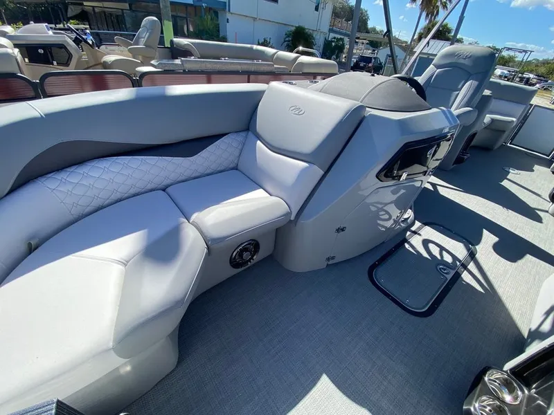 Slide: The Image of 2022 Manitou 23 Encore RF VP boat interior with luxurious seating and modern design. - 10
